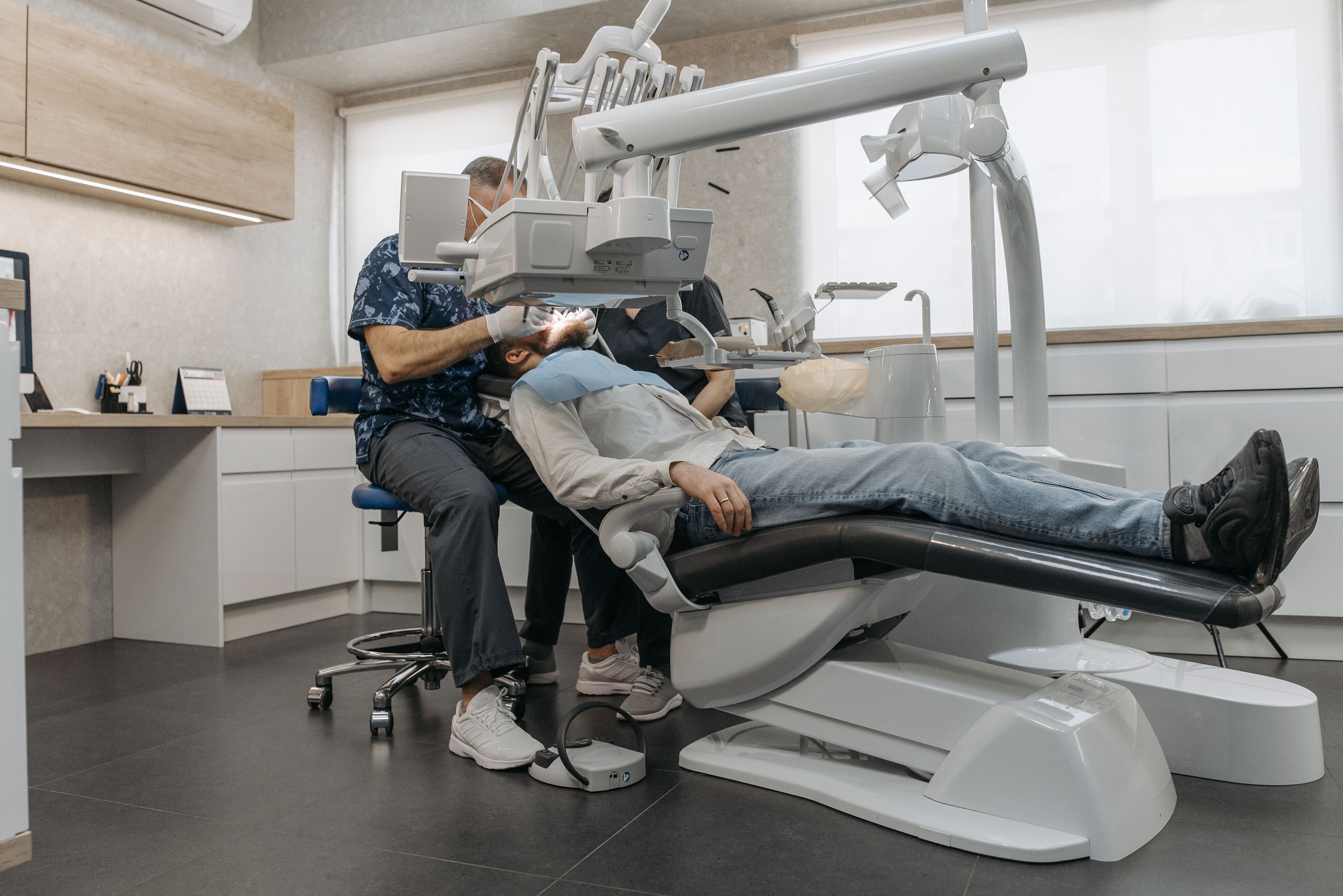 Friendly dentist talking with a patient in a bright modern office